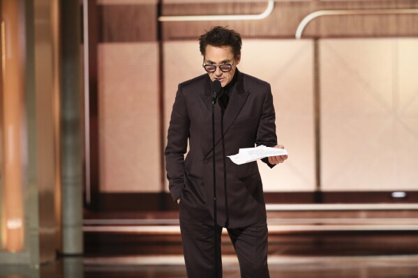 This image released by CBS shows Robert Downey Jr. accepting the award for best supporting actor in a motion picture for his role in "Oppenheimer" during the 81st Annual Golden Globe Awards in Beverly Hills, Calif., on Sunday, Jan. 7, 2024. (Sonja Flemming/CBS via AP)
