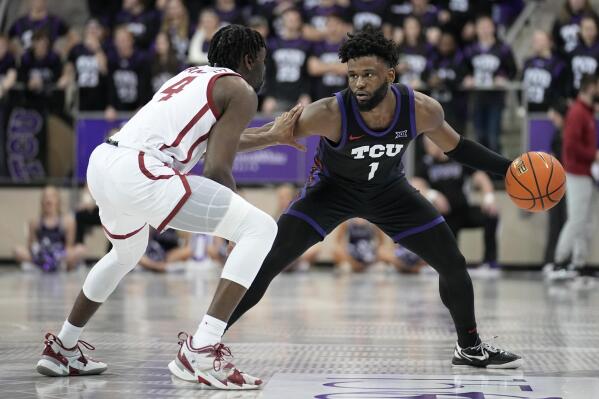 Oklahoma guard Joe Bamisile (4) defends as TCU guard Mike Miles Jr. (1) looks to make a pass in the second half of an NCAA college basketball game, Tuesday, Jan. 24, 2023, in Fort Worth, Texas. (AP Photo/Tony Gutierrez)