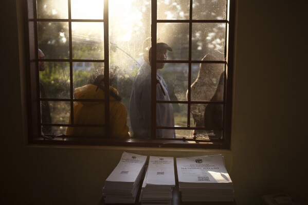 Voters wait outside a polling station on Wednesday, May 29, 2024, during the general election in Kwa Mfana, South Africa.  South African voters cast their ballots in elections seen as the most important in their country in 30 years, an election that may put them in uncharted territory in the short history of their democracy, as the ANC's three-decade dominance has become the target of early elections.  A new generation of discontent in a country of 62 million people, half of whom are estimated to live in poverty.  (AP Photo/Emilio Morenatti)