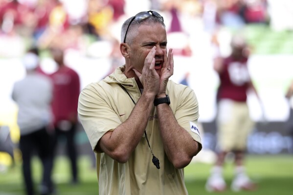 Florida State head coach Mike Norvell shouts during a warm up for the NCAA college football game between Georgia Tech and Florida State at the Aviva stadium Dublin, Saturday, Aug. 24, 2024. (AP Photo/Peter Morrison)