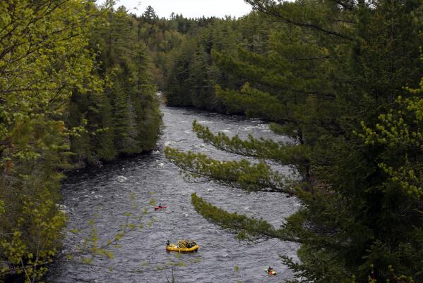 FILE - Whitewater rafters paddle on the Kennebec River in The Forks, Maine, on May 28, 2019. On the Kennebec River, conservation groups and state environmental agencies are pushing for the removal of four hydropower dams that block endangered Atlantic salmon from reaching habitat. The dams generate about 5% of the state’s renewable energy. (AP Photo/Robert F. Bukaty, File)