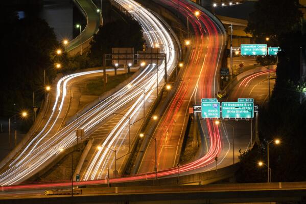 Traffic winds its way through the tangle or roads connecting the Fort Pitt Bridge with the Fort Duquesne Bridge at Pittsburgh's Point on Tuesday, Aug. 30, 2022. (Steve Mellon/Pittsburgh Post-Gazette via AP)