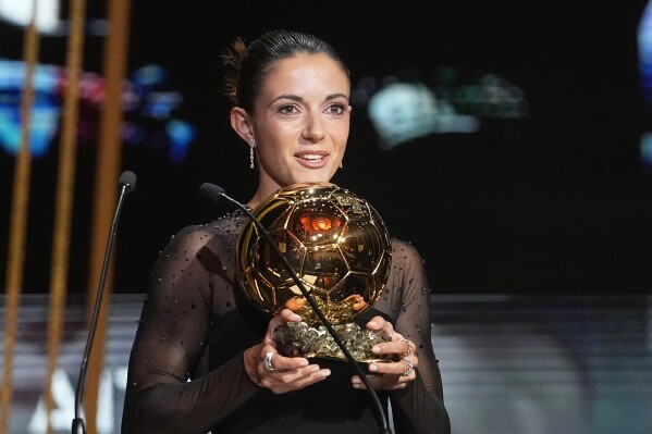 FC Barcelona's and Spain's national team midfielder Aitana Bonmati holds the trophy as she receives the 2023 Women's Ballon d'Or award during the 67th Ballon d'Or (Golden Ball) award ceremony at Theatre du Chatelet in Paris, France, Monday, Oct. 30, 2023. (AP Photo/Michel Euler)
