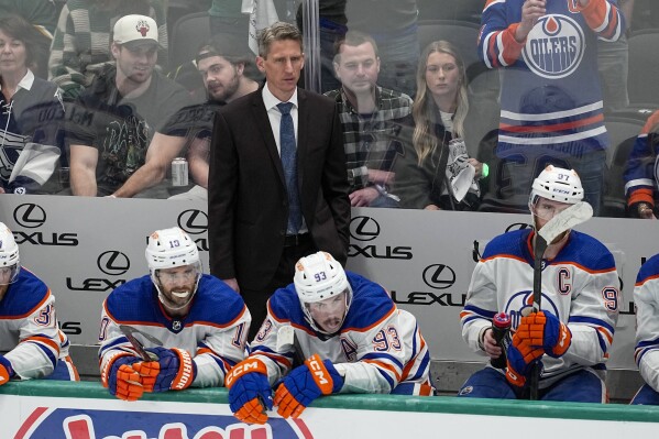 Edmonton Oilers head coach Kris Knoblauch, top, looks on during the third period in Game 1 of the NHL hockey Western Conference Stanley Cup playoff finals against the Dallas Stars, Thursday, May 23, 2024, in Dallas. (AP Photo/Tony Gutierrez)