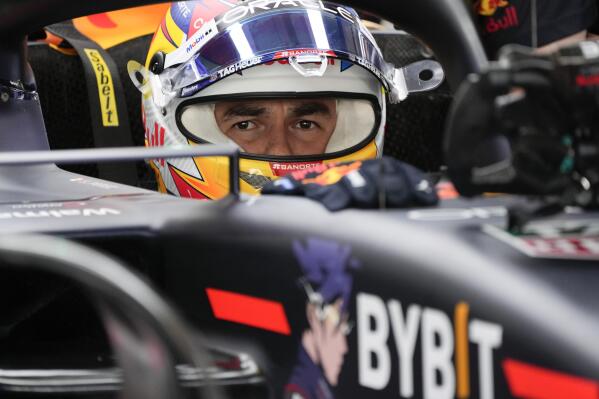 Red Bull driver Sergio Perez of Mexico sits in his car during practice for thethe Formula One Abu Dhabi Grand Prix, in Abu Dhabi, United Arab Emirates Friday, Nov. 18, 2022. (AP Photo/Hussein Malla)