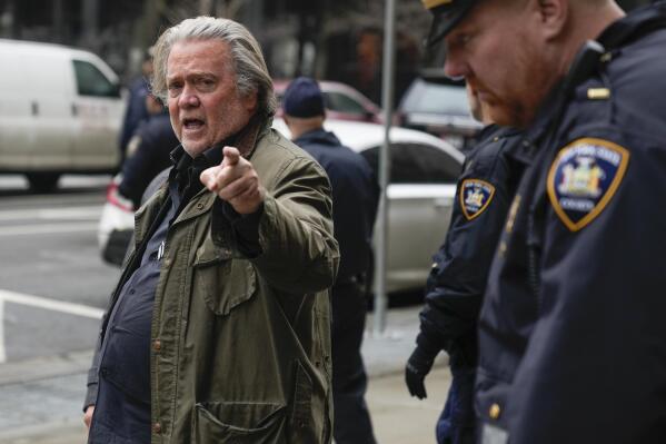 Steve Bannon, left, speaks to reporters as he leaves a courthouse in New York, Thursday, Jan. 12, 2023. (AP Photo/Seth Wenig)