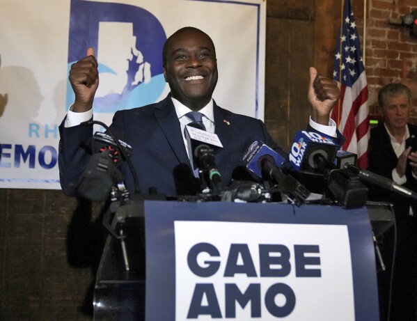 Democrat Gabe Amo gives a two thumbs up to the room full of election night supporters Tuesday, Nov. 7, 2023, at the Guild in Pawtucket, R.I., after winning Rhode Island's 1st congressional district seat.  The former White House aide will become the state's first black candidate elected to the House of Representatives.  (Kris Craig/Providence Journal via AP)