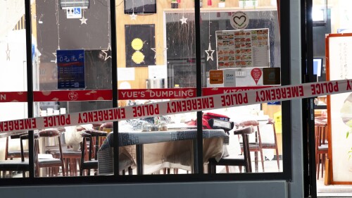 Police tape cordons off a restaurant in Auckland, New Zealand, Tuesday, June 20, 2023, after an axe attack late Monday. Multiple people were hospitalized after a man armed with an axe began attacking diners at random at three neighboring Chinese restaurants, according to police and witnesses. (Hayden Woodward/New Zealand Herald via AP)