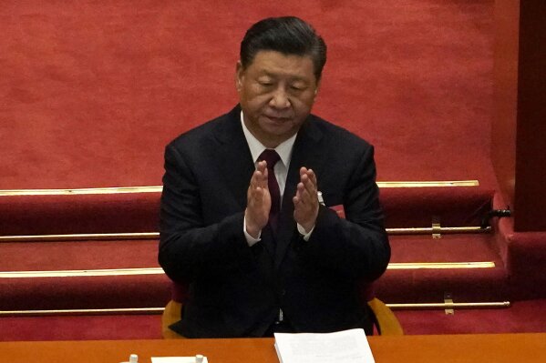 Chinese President Xi Jinping applauds during the opening session of China's National People's Congress (NPC) at the Great Hall of the People in Beijing, Friday, March 5, 2021. (AP Photo/Andy Wong)