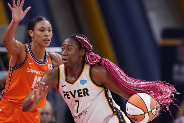 FILE - Indiana Fever's Aliyah Boston (7) is defended by Connecticut Sun's Olivia Nelson-Ododa, left, during the first half of a WNBA basketball game Aug. 4, 2023, in Indianapolis. The WNBA is using some fresh faces in its Player Marketing Agreement cohort this season. The league's past two Rookie of the Year winners, Boston and Rhyne Howard, of Atlanta, are two of the six players chosen this offseason to take part in the program. (APPhoto/Darron Cummings, File)