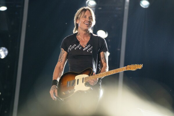 FILE - Keith Urban performs during the 2023 CMA Fest on Friday, June 9, 2023, at Nissan Stadium in Nashville, Tenn. Urban and Kix Brooks of powerhouse duo Brooks & Dunn will be inducted into the Nashville Songwriters Hall of Fame at the 53rd anniversary gala held at Nashville’s Music City Center. (Photo by Amy Harris/Invision/AP, File)