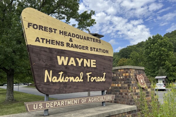A sign outside of the Wayne National Forest headquarters is posted in Nelsonville, Ohio on Tuesday, August 29, 2023. A vigorous debate is under way over a U.S. Forest Service proposal to rename the 250,000-acre Wayne National Forest after Ohio's state tree, the buckeye. (AP Photo/Patrick Orsagos)