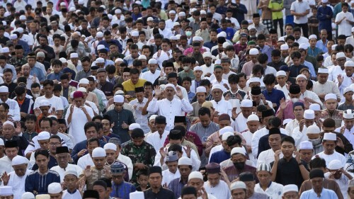 Muslims perform a morning prayer marking the Eid al-Adha holiday on a street in Jakarta, Indonesia, Thursday, June 29, 2023. (AP Photo/Tatan Syuflana)