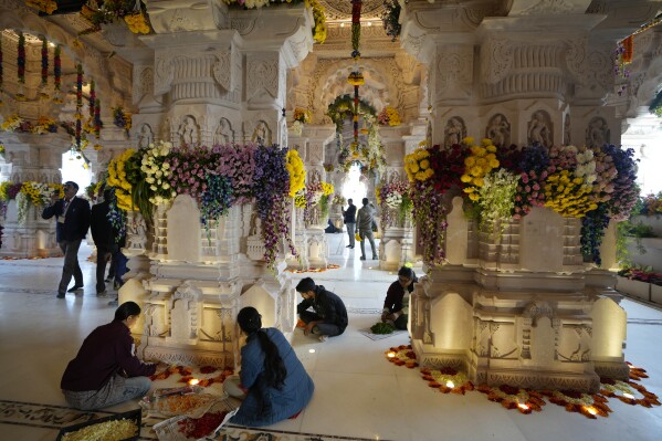 Workers decorate with flowers a temple dedicated to the Hindu deity Lord Ram, a day before the grand opening of the temple in Ayodhya, India, Sunday, Jan. 21, 2024. (AP Photo/Rajesh Kumar Singh)