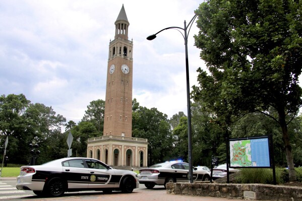 FILE - Law enforcement respond to the University of North Carolina-Chapel Hill campus in Chapel Hill, N.C., Aug. 28, 2023, after the university locked down and warned of an armed person on campus. Two shooting 30 years apart at the University of North Carolina show how much has changed. Some alumni who remember a deadly shooting in 1995 now have children enrolled at their alma mater in Chapel Hill, where an associate professor was shot to death Aug. 28. In some ways, the era of campus shootings has come full circle though there have been vast changes in the way information spreads. (AP Photo/Hannah Schoenbaum, File)