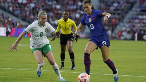 FILE - United States' Alex Morgan, right, and Ireland's Ruesha Littlejohn battle for the ball during the first half of an international friendly soccer match Tuesday, April 11, 2023, in St. Louis. Overwhelming demand for tickets meant co-host Australia's opening match against Ireland at the Women's World Cup had to be shifted to the tournament's biggest stadium and will be played in front of an expected record crowd of 82,500 on Thursday, July 20, 2023. (AP Photo/Jeff Roberson, File)