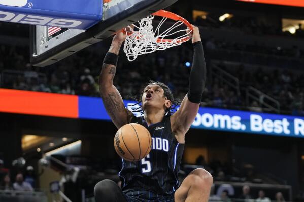 Orlando Magic's Paolo Banchero makes an uncontested dunk against the Boston Celtics during the second half of an NBA basketball game, Monday, Jan. 23, 2023, in Orlando, Fla. (AP Photo/John Raoux)