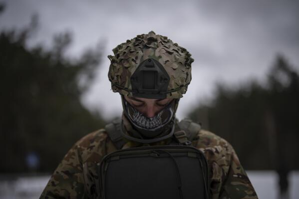 A Ukrainian serviceman controls a drone during a demonstration close to the border with Belarus, Ukraine, Wednesday, Feb. 1, 2023. Reconnaissance drones fly several times a day from Ukrainian positions across the border into Belarus, a close Russian ally, scouring for signs of trouble on the other side. Ukrainian units are monitoring the 1,000-kilometer (650-mile) frontier of marsh and woodland for a possible surprise offensive from the north, a repeat of the unsuccessful Russian thrust towards Kyiv at the start of the war nearly a year ago. (AP Photo/Daniel Cole)