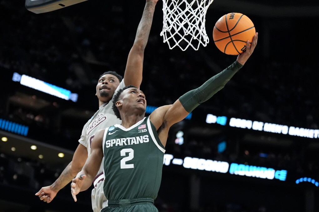 Michigan State guard Tyson Walker drives to the basket past Mississippi State forward D.J. Jeffries during the first half of a first-round college basketball game in the NCAA Tournament, Thursday, March 21, 2024, in Charlotte, N.C. (AP Photo/Chris Carlson)