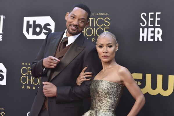 FILE - Will Smith, left, and Jada Pinkett Smith arrive at the 27th annual Critics Choice Awards in Los Angeles on March 13, 2022. Pinkett Smith and husband Will Smith have lived what she says are “completely separate lives” since 2016. Pinkett Smith made the revelation in an interview with Hoda Kotb. The prominent Hollywood couple married in 1997 and have addressed separations and marital troubles. But never this specifically. (Photo by Jordan Strauss/Invision/AP, File)