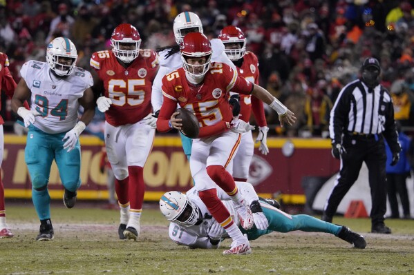 FILE -Kansas City Chiefs quarterback Patrick Mahomes (15) runs against Miami Dolphins defensive end Emmanuel Ogbah (91) during an NFL wild-card playoff football game Saturday, Jan. 13, 2024 in Kansas City, Mo. There are a variety of ways a game can change, and that鈥檚 been evident in the games that led to this week鈥檚 Super Bowl matchup between Kansas City and San Francisco.(AP Photo/Ed Zurga, File)