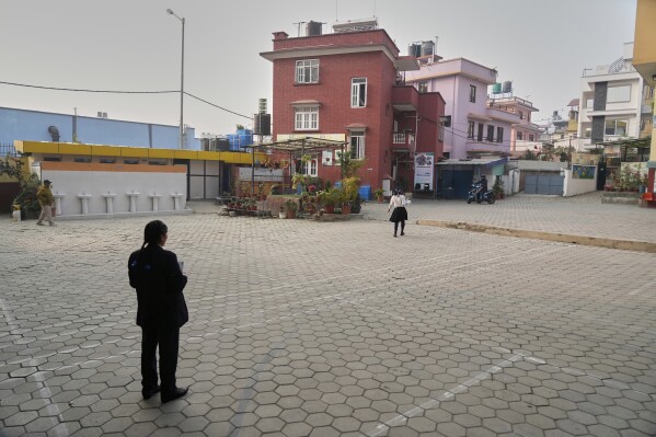 Nirmala Pariyar, left, looking at her friend Khendo Tamang, right, saying goodbye after being together for 10 years in Lalitpur, Nepal, on Thursday, March 27, 2025.
