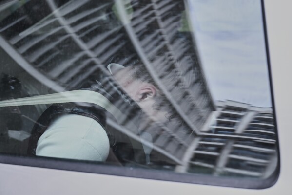 A 17-year-old Polish high school student, arrested in Greece on an international warrant for a murder in his home town of Mlawa, in northeastern Poland, is seen in a police vehicle after making a court appearance in Thessaloniki, northern Greece, on Monday, May 5, 2025. (AP Photo/Giannis Papanikos)