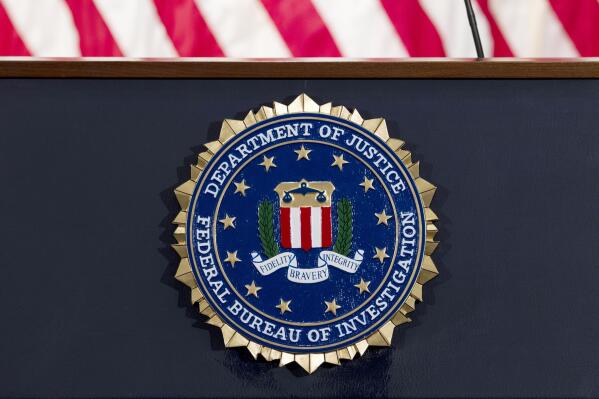 FILE - The FBI seal is displayed on a podium before a news conference at the agency's headquarters on June 14, 2018, in Washington. A U.S. senator is pressing the FBI for more information after a whistleblower alleged that an internal review found 665 FBI personnel have resigned or retired to avoid accountability in misconduct probes over the past two decades, according to a letter early from the senator early Oct. 2022. (AP Photo/Jose Luis Magana, File)