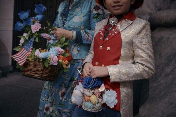 Revelers wearing decorated hats and costumes participate in the annual Easter Parade and Bonnet Festival in front of St. Patrick's Cathedral on Sunday, April 20, 2025, in New York. (AP Photo/Andres Kudacki)