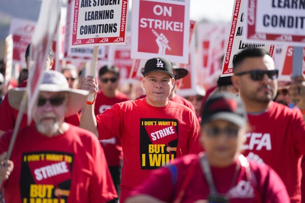 Members of the California Faculty Association rally and picket during a strike at California State Polytechnic University, Pomona, on Monday, Dec. 4, 2023, in Pomona, Calif. (AP Photo/Ashley Landis)