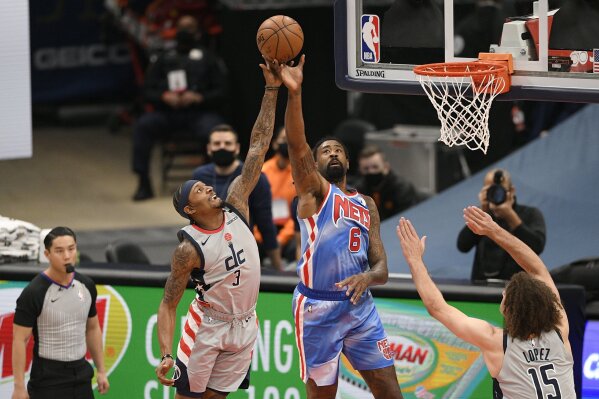 Washington Wizards guard Bradley Beal (3) and Brooklyn Nets center DeAndre Jordan (6) battle for the ball during the first half of an NBA basketball game, Sunday, Jan. 31, 2021, in Washington. Also seen is Wizards center Robin Lopez (15). (AP Photo/Nick Wass)