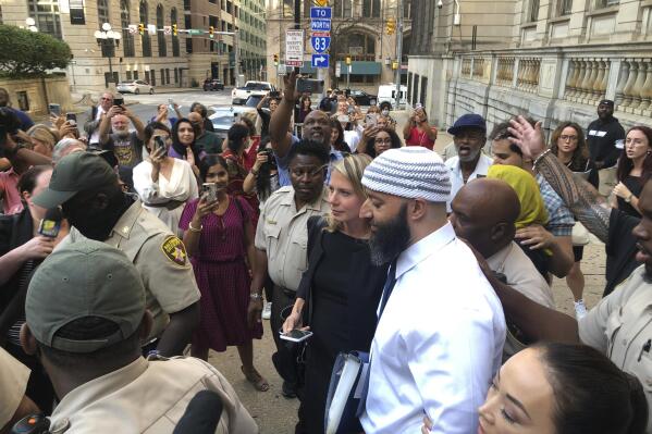 FILE - Adnan Syed, center, leaves the Cummings Courthouse, Monday, Sept. 19, 2022, in Baltimore. An appeal of the court proceedings that freed Adnan Syed from prison filed by the family of the murder victim in the case chronicled in the true-crime podcast “Serial” can move forward. Maryland’s intermediate appellate court made the ruling Friday, Nov. 4, 2022 (AP Photo/Brian Witte, File)