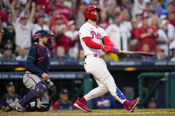 Philadelphia Phillies' Bryce Harper hits a three run home run during the third inning of Game 3 of a baseball NL Division Series against the Atlanta Braves Wednesday, Oct. 11, 2023, in Philadelphia. (AP Photo/Matt Slocum)