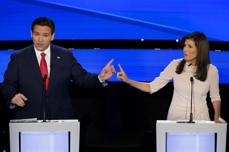 FILE - Former UN Ambassador Nikki Haley, right and Florida Gov. Ron DeSantis, left, pointing at each other during the CNN Republican presidential debate at Drake University in Des Moines, Iowa, Jan. 10, 2024. As Republican primary voters prepare to cast ballots for who they believe should lead the U.S. into its future, leading candidates are struggling to discuss key elements of the nation’s past. DeSantis, Haley and former President Donald Trump have all raised eyebrows with rhetoric on the Civil War and slavery. (AP Photo/Andrew Harnik, File)