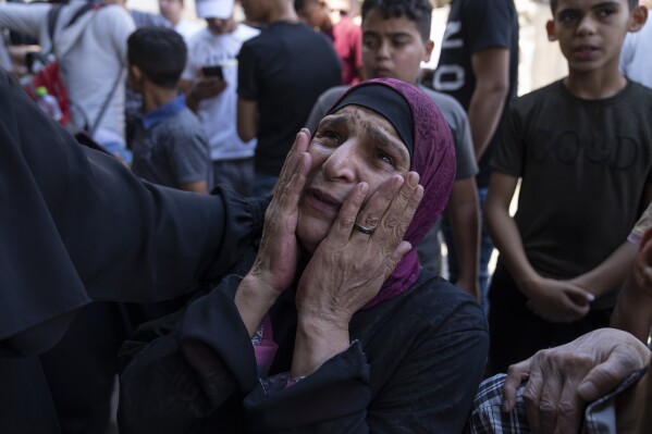 FILE - Khayriah, mother of Hamza Maqbool, cries during his funeral in the West Bank city of Nablus, Friday, July 7, 2023. Israeli troops have shot and killed a Palestinian man during new unrest in the West Bank. The shooting on Monday, July 10, came as a wave of violence in the occupied territory showed no signs of slowing. Israel last week concluded a fierce two-day offensive that used rare air power and hundreds of troops in what was meant as a crackdown against militants. (AP Photo/Nasser Nasser, File)