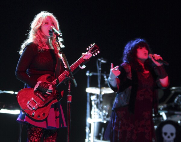 FILE - Nancy and Ann Wilson of the classic rock band Heart perform in concert at the American Music Theater on Monday, March 24, 2014, in Lancaster, Pa. Heart — the pioneering band that melds Nancy Wilson’s shredding guitar with her sister Ann’s powerhouse vocals — is hitting the road this spring for a world tour that Nancy Wilson describes as “the full-on rocker size.” (Photo by Owen Sweeney/Invision/AP, File)