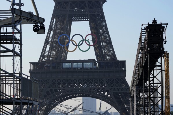 The Olympic rings are seen on the Eiffel Tower Friday, June 7, 2024 in Paris. The Paris Olympics organizers mounted the rings on the Eiffel Tower on Friday as the French capital marks 50 days until the start of the Summer Games. The 95-foot-long and 43-foot-high structure of five rings, made entirely of recycled French steel, will be displayed on the south side of the 135-year-old historic landmark in central Paris, overlooking the Seine River. (AP Photo/Michel Euler)