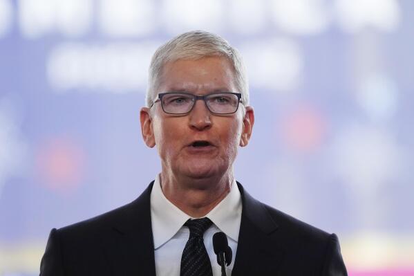 FILE - Apple CEO Tim Cook speaks in front of the new Taiwan Semiconductor Manufacturing Company facility under construction in Phoenix, Tuesday, Dec. 6, 2022. Cook will take a more than 40% pay cut this year from a year earlier as the company adjusts how it calculates his compensation. Apple Inc. said in a regulatory filing that Cook’s target total compensation is $49 million for 2023. (AP Photo/Ross D. Franklin, File)