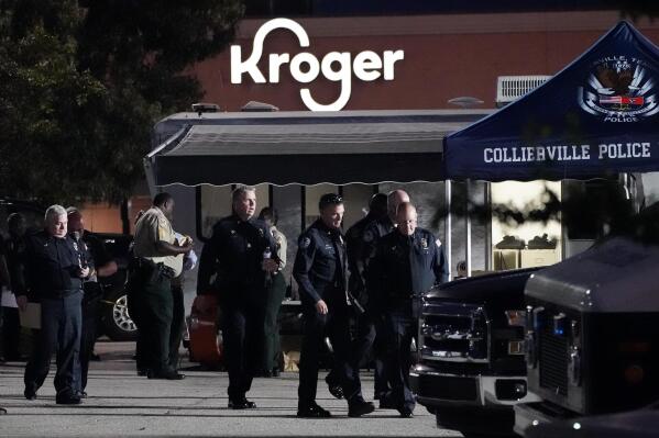 Law enforcement personnel work in front of a Kroger grocery store as an investigation goes into the night following a shooting earlier in the day on Thursday, Sept. 23, 2021, in Collierville, Tenn. Police say a gunman attacked people in the store and killed at least one person and wounded 12 others before the suspect was found dead. (AP Photo/Mark Humphrey)