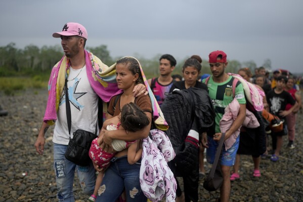 FILE - Migrants line up to take a boat after walking across the Darien Gap from Colombia, in Bajo Chiquito, Panama, May 7, 2023. The nation has also become the epicenter of a steady flow of migration through the perilous jungles of the Darien Gap running along the Colombia-Panama border. (AP Photo/Natacha Pisarenko, File)