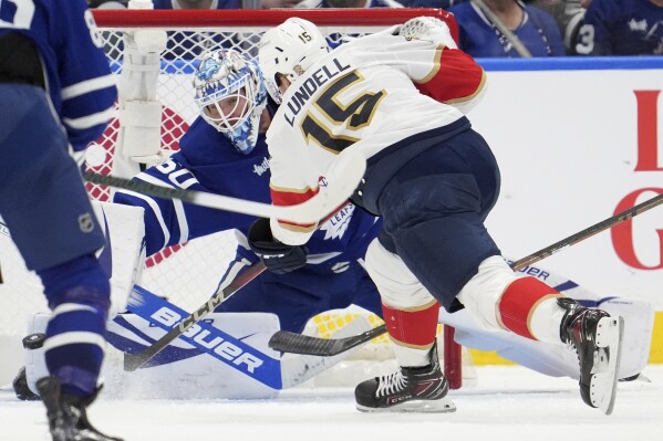 Florida Panthers centerAnton Lundell (15) scores against Toronto Maple Leafs goaltender Joseph Woll (60) during the second period of Game 7 of a second-round NHL hockey playoff series in Toronto, Sunday, May 18, 2025. (Frank Gunn/The Canadian Press via AP)