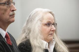 FILE - Kathy Funk and her attorney Philip H. Beauvais III appear in court, Wednesday, Jan. 25, 2023, in Flint, Mich. Funk, a local official in Michigan accused of breaking a seal on a ballot box in her own election to ensure that votes couldn't be recounted was sentenced Monday, April 24, to six months of house arrest. (Brice Tucker/The Flint Journal via AP, File)