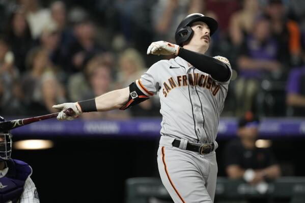 San Francisco Giants' Mike Yastrzemski follows the flight of his solo home run off Colorado Rockies relief pitcher Daniel Bard in the ninth inning of a baseball game Monday, May 16, 2022, in Denver. (AP Photo/David Zalubowski)