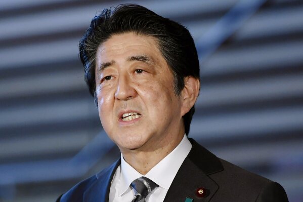 Japanese Prime Minister Shinzo Abe speaks to reporters at his official residence in Tokyo Friday, May 1, 2020. Abe told reporters Friday that the coronavirus state of emergency that is supposed to end next week will have to be kept in place roughly for another month. (Kyodo News via AP)
