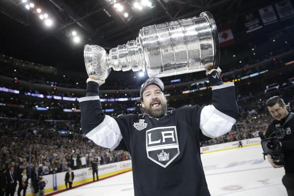 FILE - Los Angeles Kings right wing Justin Williams, of Slovenia, carries the Stanley Cup after defeating the New York Rangers in Game 5 of the NHL Stanley Cup Final series, June 13, 2014, in Los Angeles. Williams is joining NHL Network as a guest analyst for Games 3 and 4 of the final between the Colorado Avalanche and Tampa Bay Lightning. Williams played 19 seasons and hopes that experience lends itself to television.  (AP Photo/Jae C. Hong)