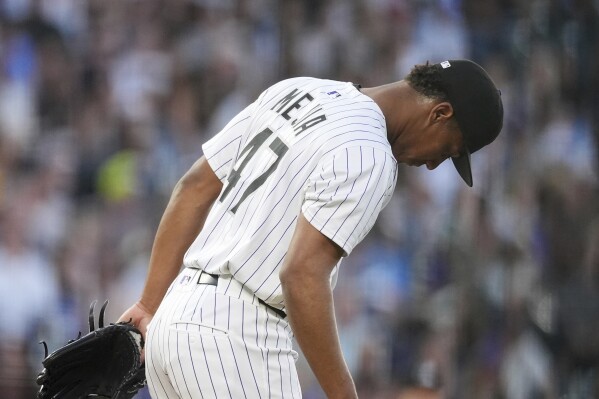 Colorado Rockies relief pitcher Juan Mejia reacts after giving up a three-run home run to San Diego Padres' Fernando Tatis Jr. in the fifth inning of a baseball game Saturday, May 10, 2025, in Denver. (AP Photo/David Zalubowski)