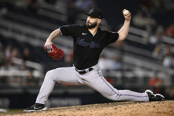FILE - Miami Marlins relief pitcher Tanner Scott throws to a Washington Nationals batter during the 11th inning of a baseball game Sept. 1, 2023, in Washington. In arbitartion, Scott is asking for $5.7 million instead of the Marlins’ $5.15 million offer. (AP Photo/Nick Wass, File)