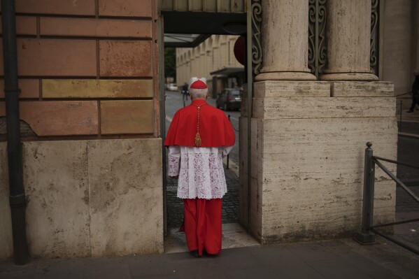 Cardinal Giuseppe Versaldi walks through the St. Anna gate, at the Vatican, Wednesday, May 7, 2025. (AP Photo/Francisco Seco)