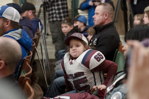 FILE - Bruce Bertram, 7, listens as lawmakers discuss a proposed bill that would ban children under 12 from playing tackle football in California Wednesday, Jan. 10, 2024, in Sacramento, Calif. California Gov. Gavin Newsom said he would not sign the bill, saying he is concerned about the health and safety of young athletes but an outright ban is not the answer. (AP Photo/Rich Pedroncelli,File)