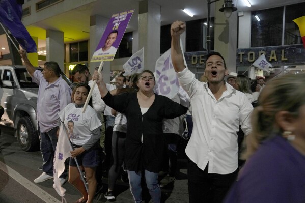 Supporters of Daniel Noboa, presidential candidate for National Democratic Action Alliance, celebrate after listening to results in the snap presidential elections, in the streets of Guayaquil, Ecuador, Sunday, Aug. 20, 2023. (AP Photo/Martin Mejia)